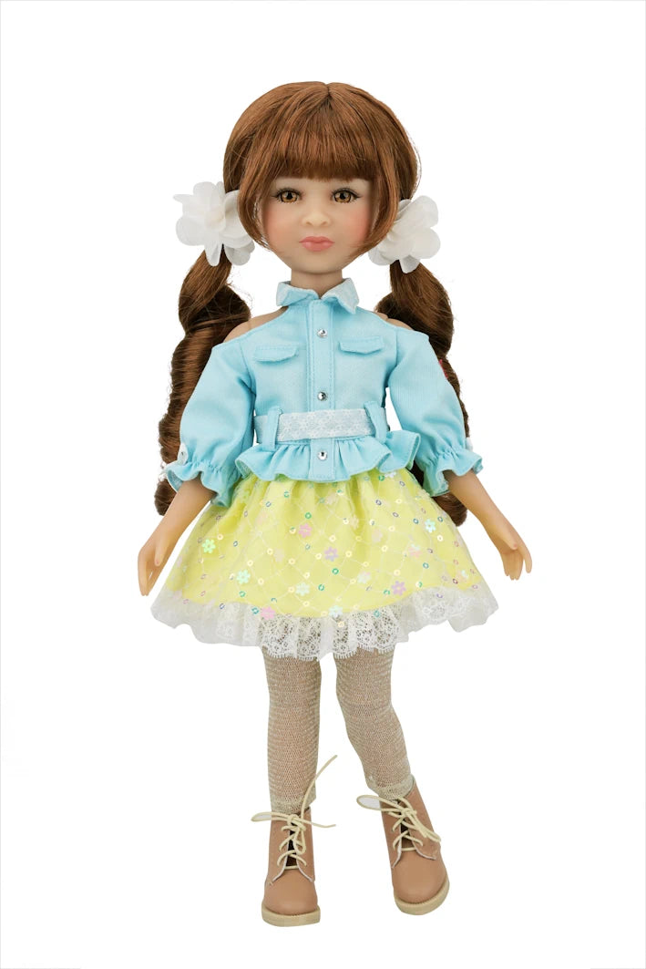 Valeria wearing a light blue shirt and yellow skirt with white lace trim on a white background