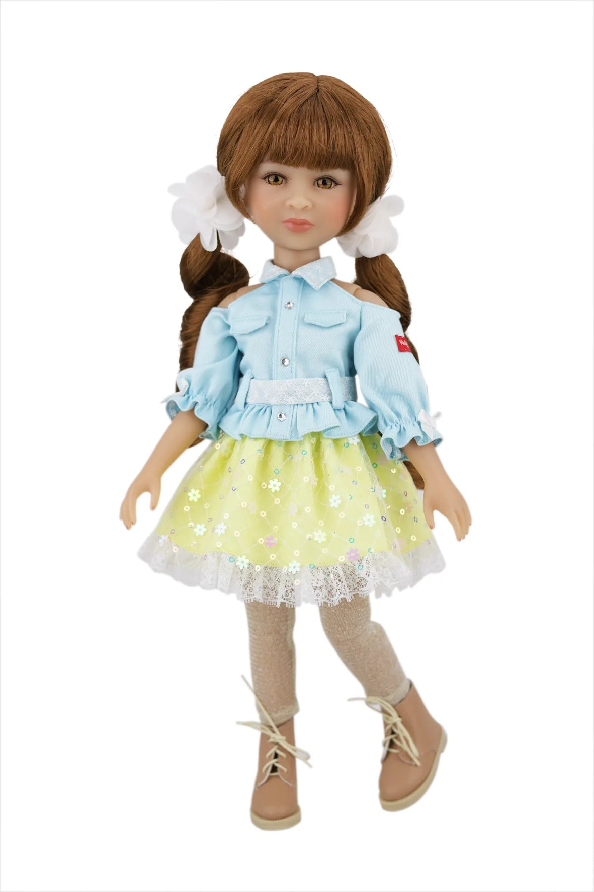 Valeria with a light blue top and yellow polka dot skirt on a white background