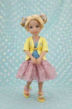 Juniper wearing a yellow cardigan, pink skirt, and sandals on a light blue background