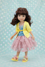 Juniper wearing a yellow jacket, blue shirt, and pink dress with a floral pattern on a light blue background.