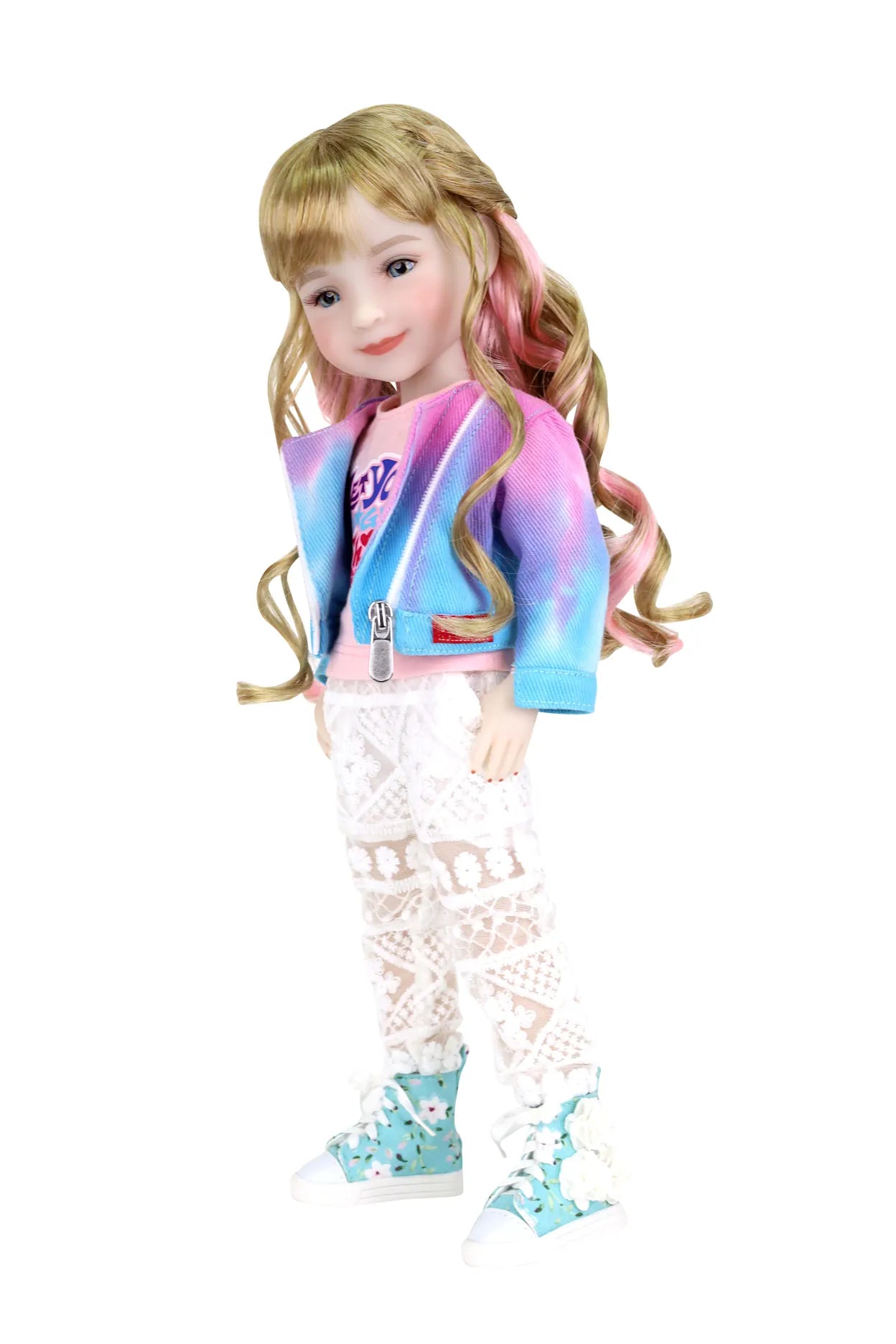 Sara, blonde hair with pink highlights, in tie-dye jacket, pink top, lace pants, hand in pocket, white background.