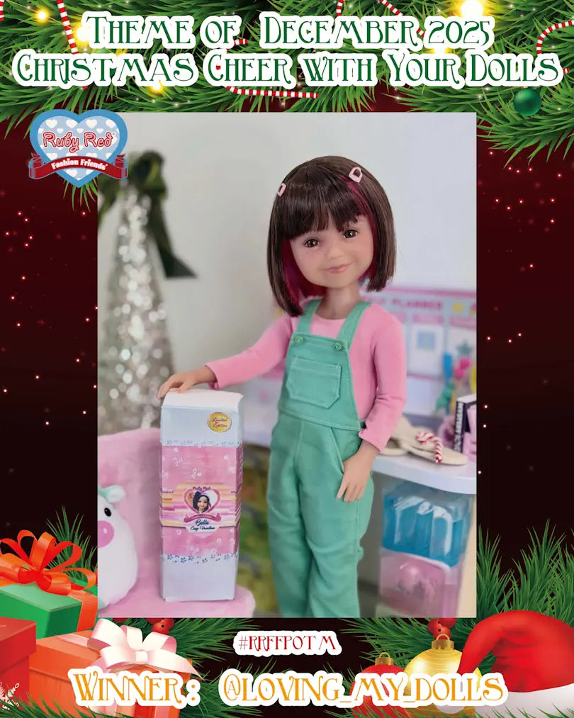 Doll in green overalls and pink shirt with a box, surrounded by Christmas decorations.