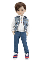 Doll wearing a denim vest, white hoodie, blue jeans, and colorful sneakers on a white background
