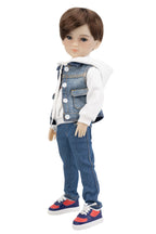 Doll wearing a denim outfit with a white shirt on a white background
