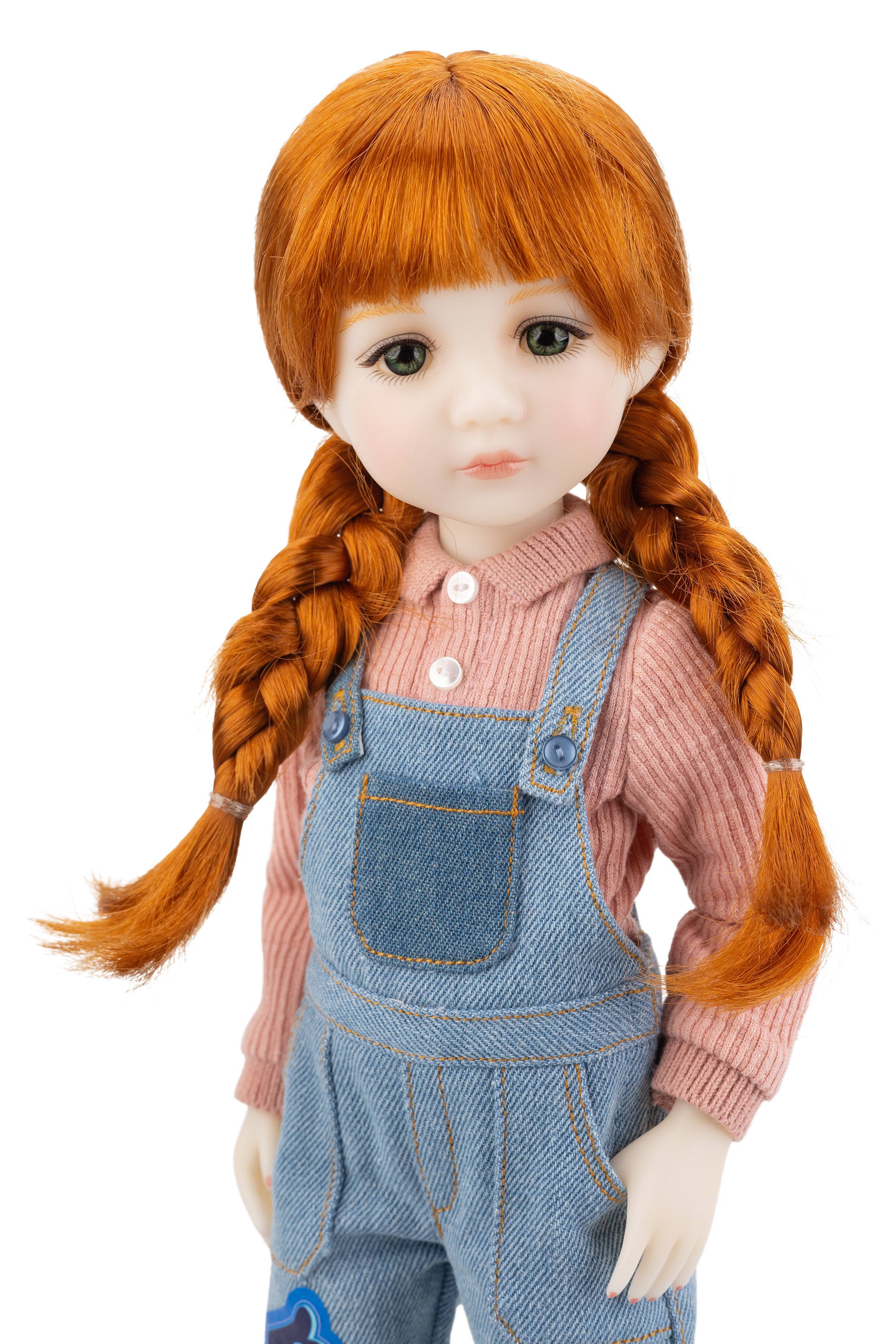 Doll with red hair styled in pigtails, wearing a pink shirt and blue overalls on a white background.