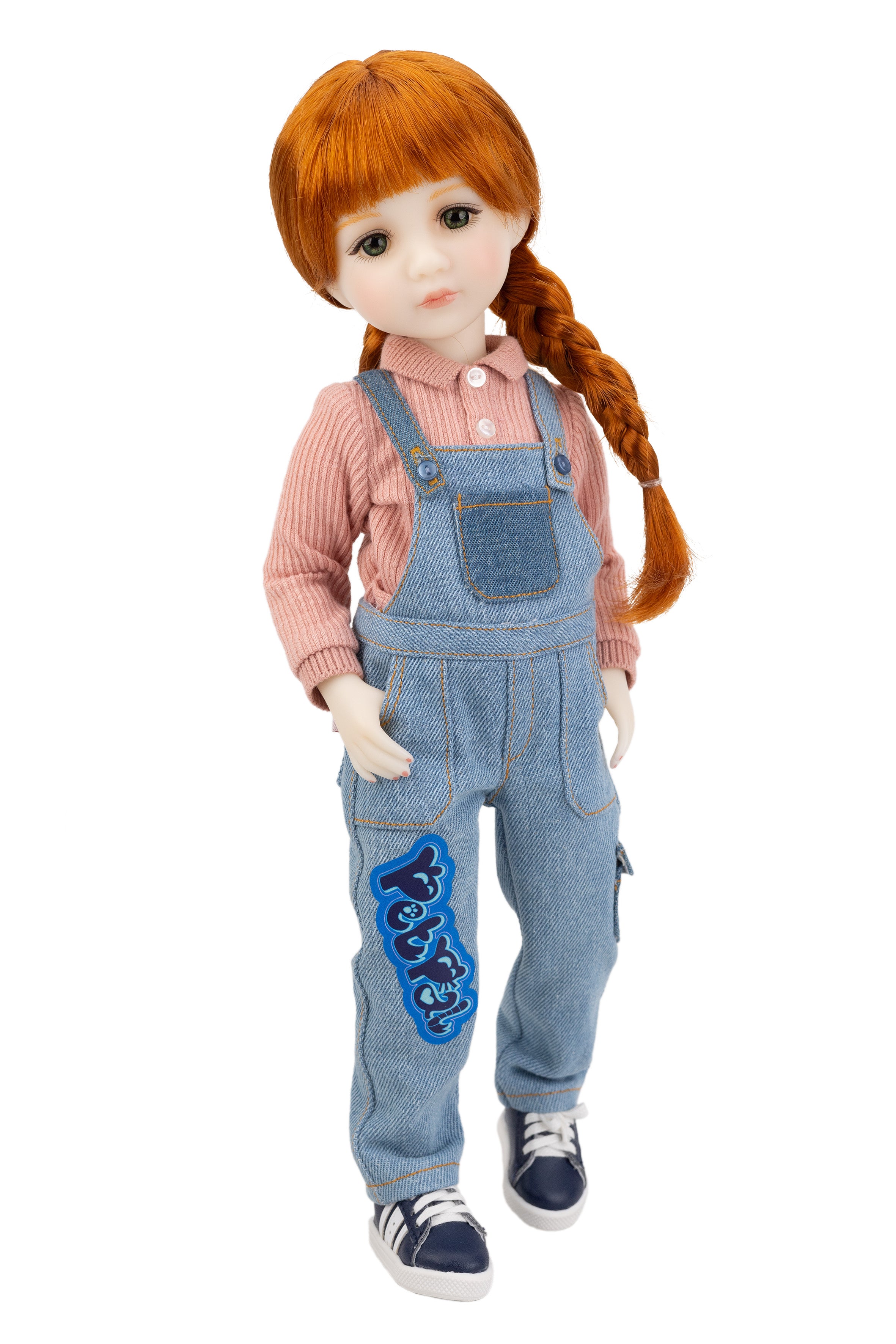 Doll with red hair styled in pigtails, wearing a pink shirt and blue denim overalls with a blue design.