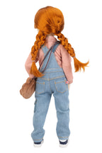 Doll with red hair styled in pigtails, wearing a pink shirt and blue overalls, on a white background.