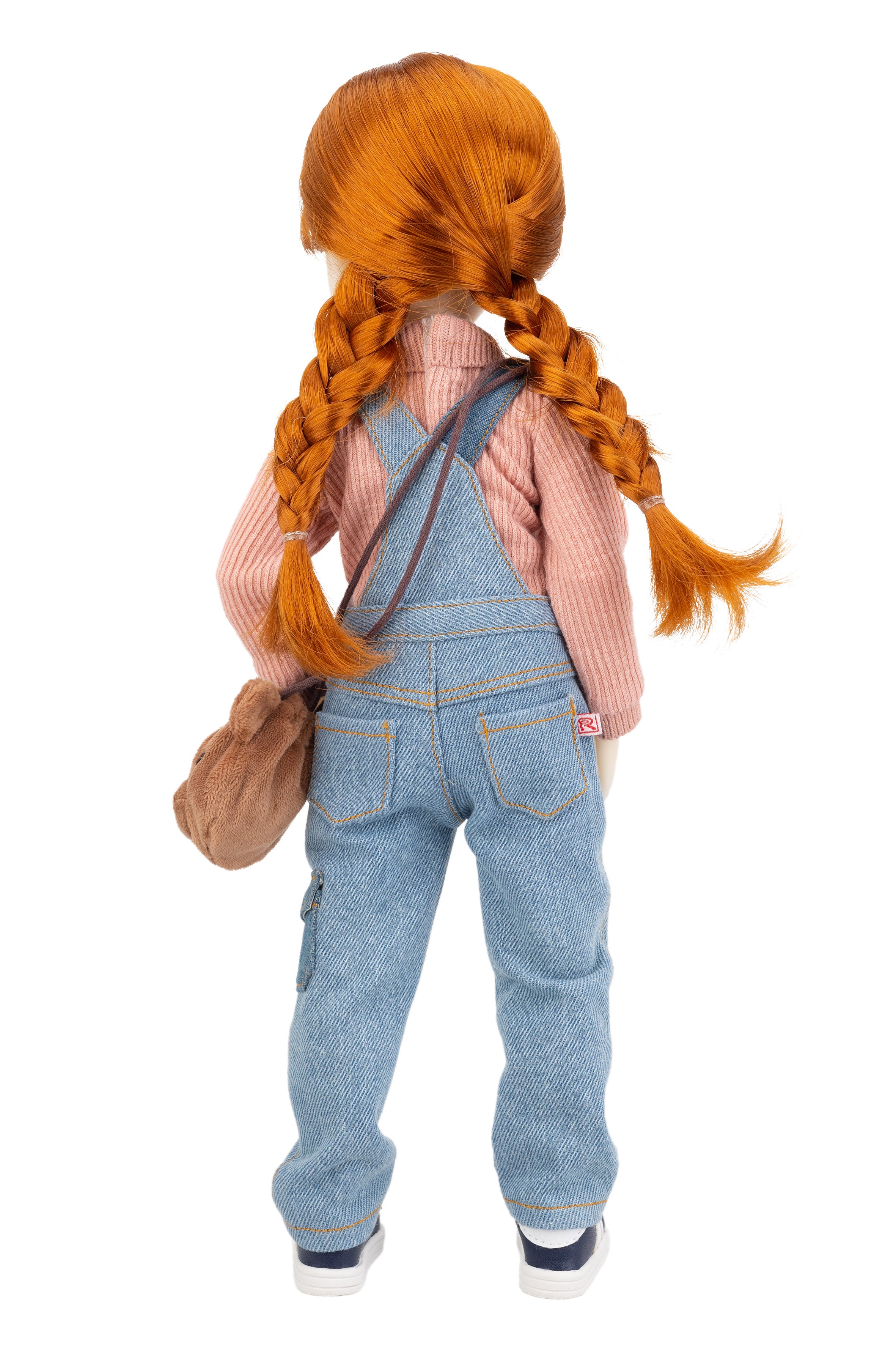 Doll with red hair styled in pigtails, wearing a pink shirt and blue overalls, on a white background.