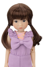 Doll with brown hair in pigtails wearing a purple dress with a large bow on a white background