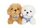 Two plush toy dogs, one brown and one white, wearing blue outfits on a white background.