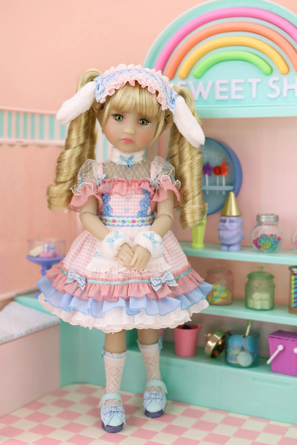 Doll in a colorful room with a rainbow and shelves.