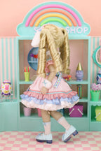 Doll in a colorful room with shelves and a rainbow arch.