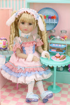 Doll in a vintage outfit with a checkered floor and pastel-colored furniture.