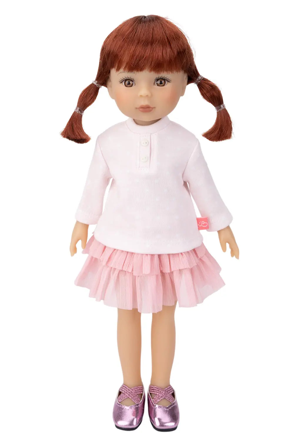 Doll with red hair in pigtails wearing a white shirt and pink skirt on a white background