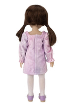 Doll wearing a pink dress with puffed sleeves on a white background
