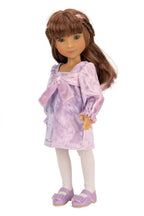 Doll wearing a purple tie-dye dress with a bow on a white background