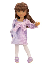 Doll wearing a purple tie-dye dress with a bow on a white background
