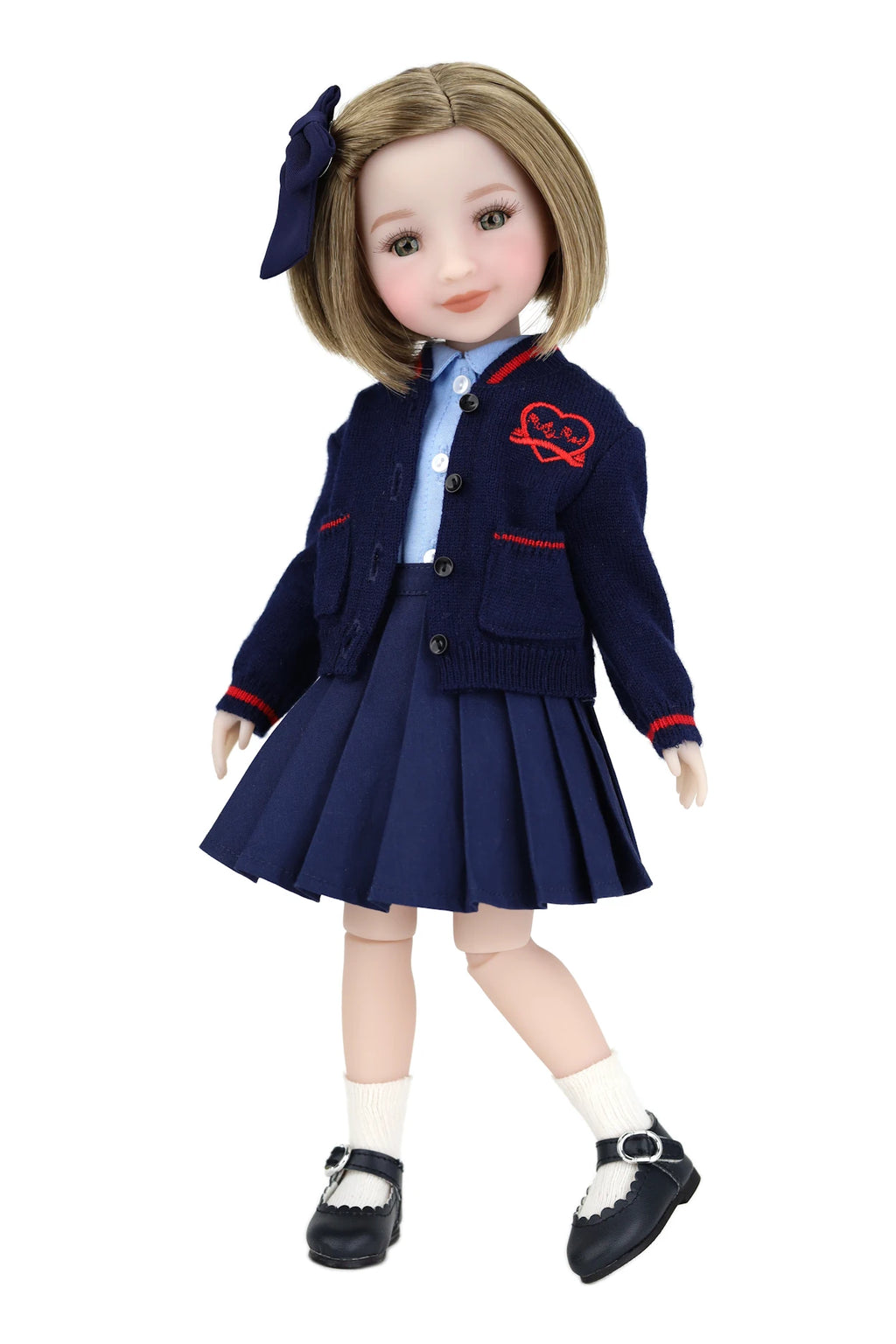 Doll wearing a navy blue school uniform with a white shirt and black shoes on a white background