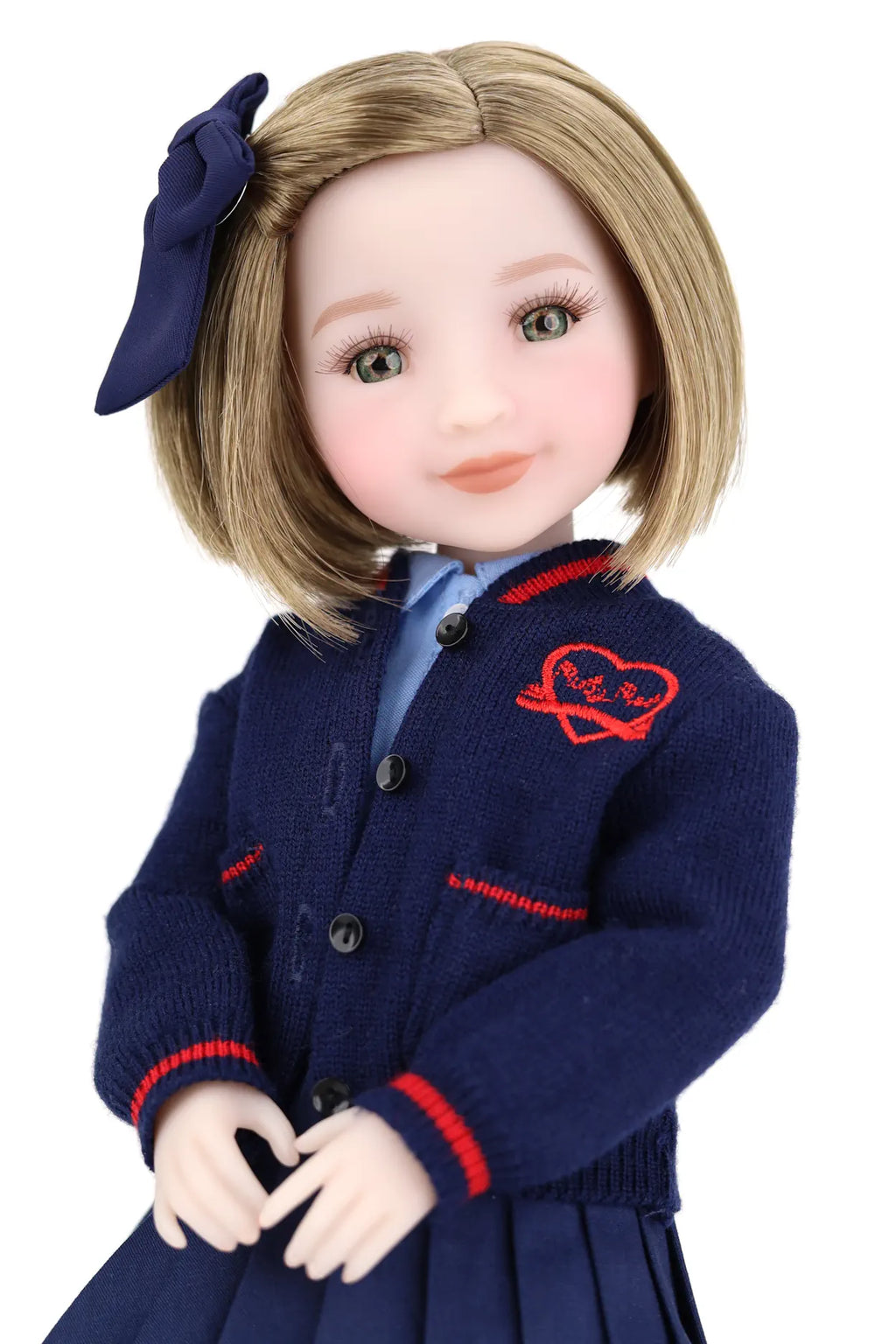 Doll wearing a navy blue cardigan with red accents on a white background