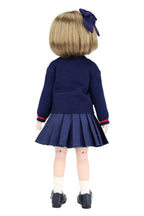 Back view of a doll wearing a navy blue outfit with a pleated skirt and bow hair accessory on a white background.