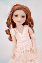 Doll with long brown hair and a white dress on a light background