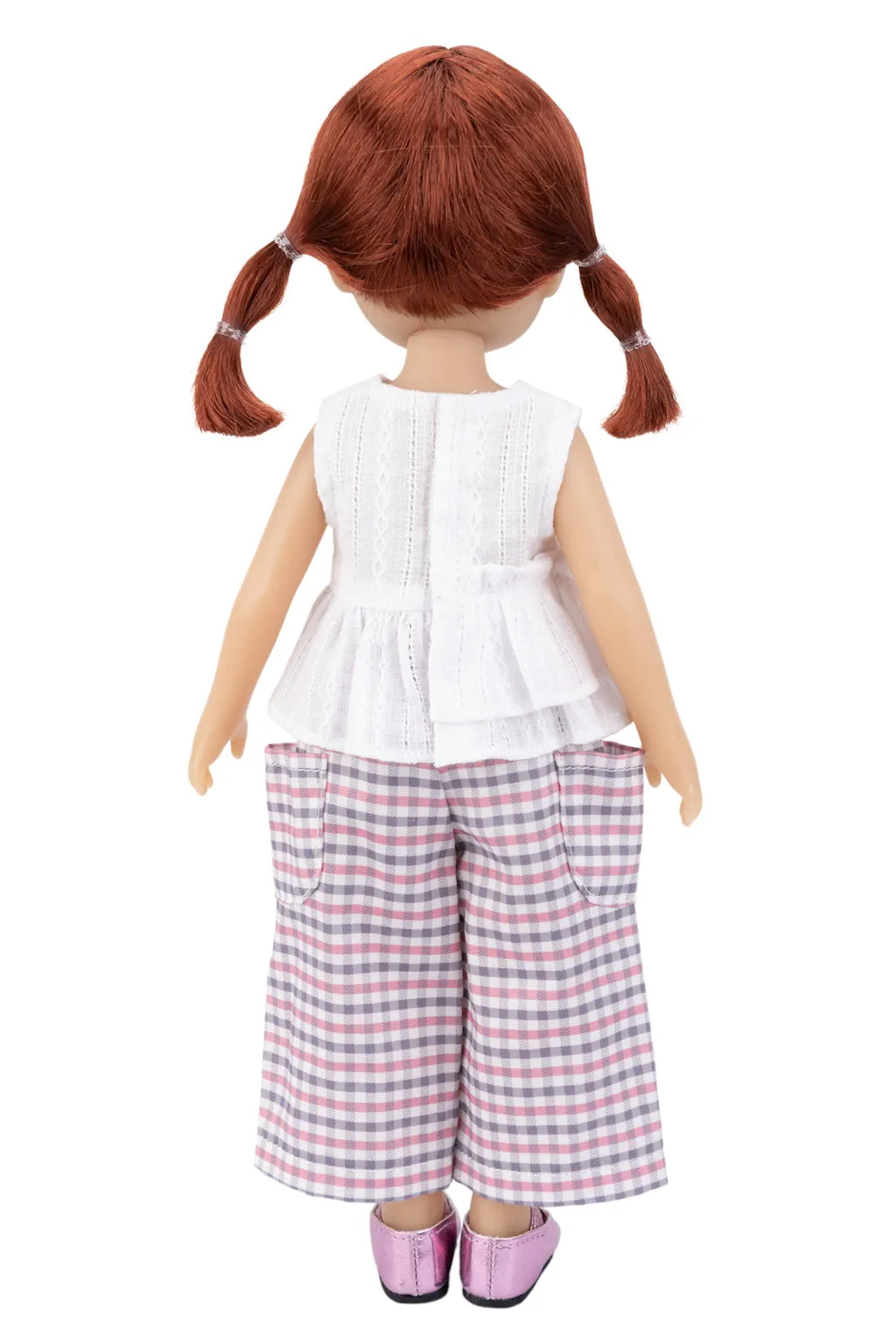 Doll with red hair styled in pigtails wearing a white top and red, blue adnd white checkered pants on a white background