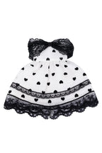 Black and white polka dot dress with a bow on a white background