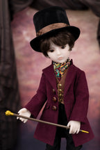 Doll in a vintage outfit with a top hat and cane against a blurred background
