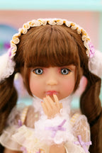 Doll with brown hair and a decorative headband in a blurred indoor setting