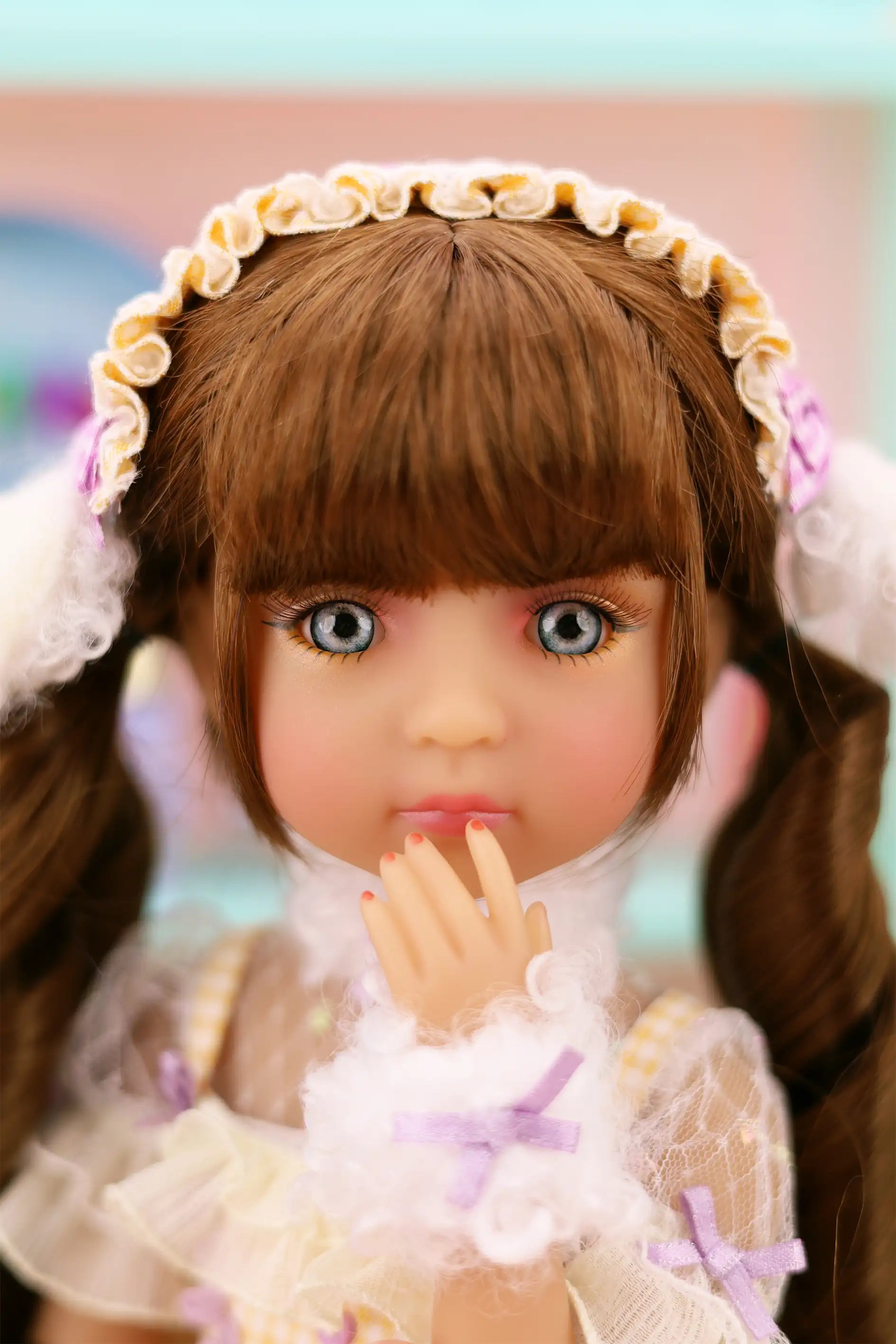 Doll with brown hair and a decorative headband in a blurred indoor setting