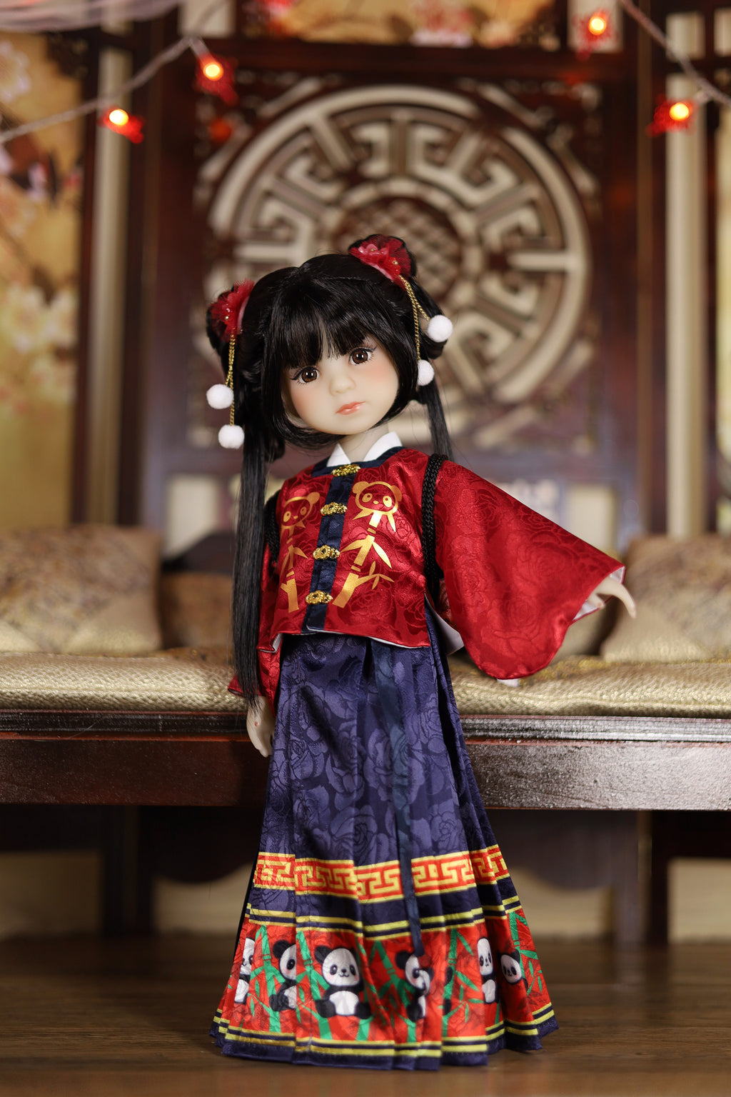 Traditional doll in red and blue outfit with intricate patterns on a wooden bench.