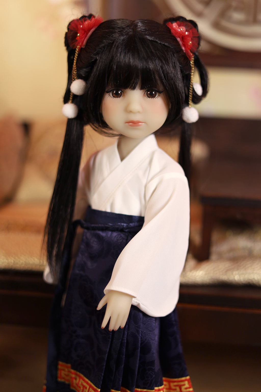  Doll with traditional outfit and hair accessories in a blurred indoor setting