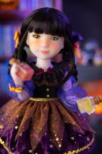 Doll with black hair styled in pigtails, wearing a black and purple outfit with gold accents.