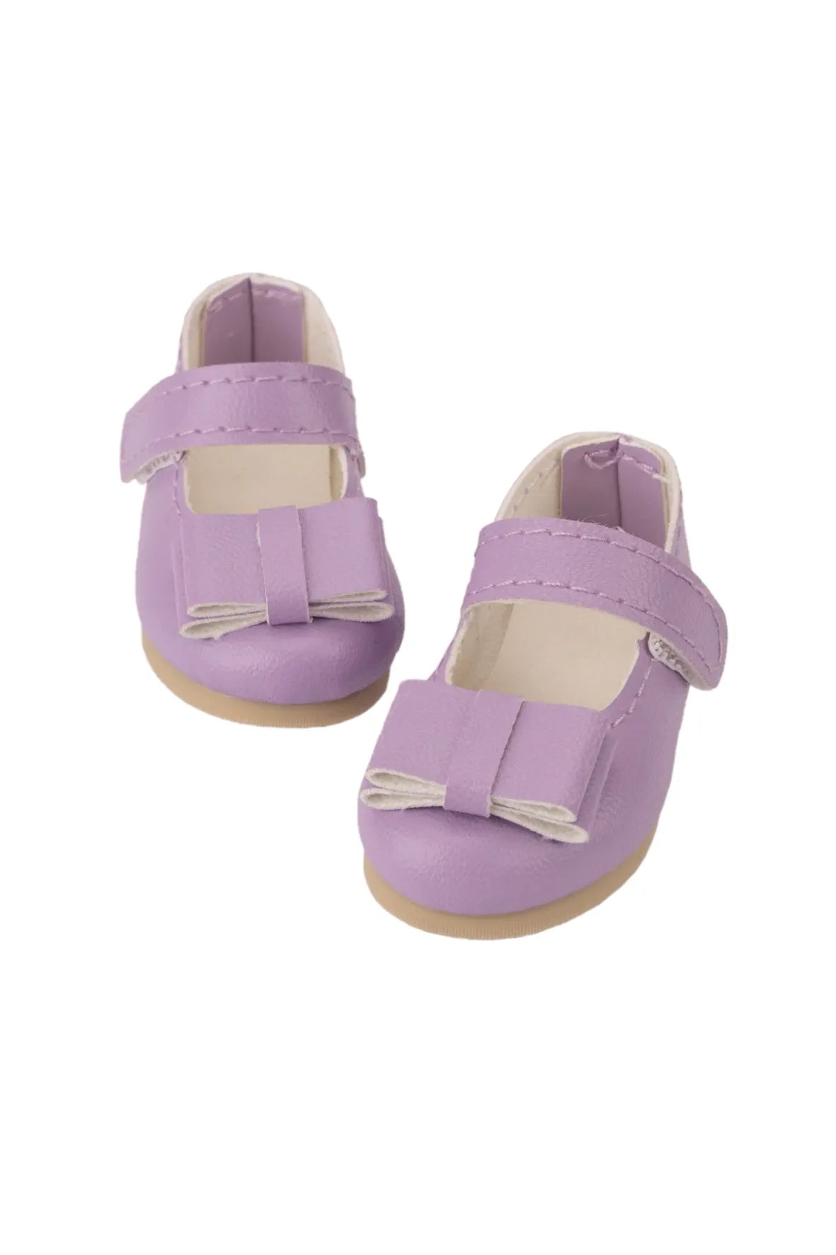 Pair of purple doll shoes with bow details on a white background