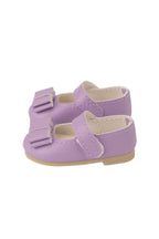 Pair of purple doll shoes with a bow on a white background